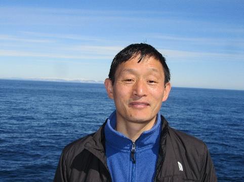 Zongbo Shi on RRS Discovery (ice-capped Greenland in the background).