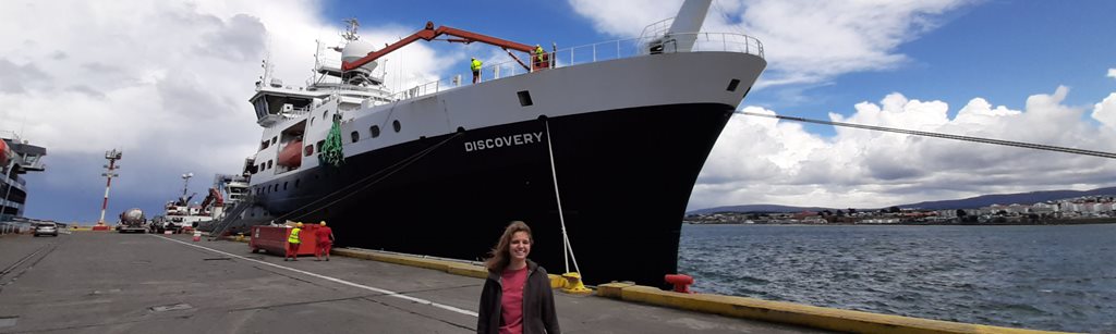 Ophelie Meuriot standing in front of the RRS discovery in port